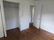 Simple bedroom with wood-look floors and a double door closet at 1420 Ne 22Nd St, Ocala, FL 34470