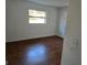 Spacious bedroom featuring wood flooring and a large window at 1420 Ne 22Nd St, Ocala, FL 34470
