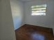 Well-lit bedroom with wood floors and a window offering street view at 1420 Ne 22Nd St, Ocala, FL 34470