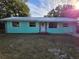 Charming single-story home with a teal exterior and a stone accent at 1420 Ne 22Nd St, Ocala, FL 34470