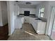 Efficient kitchen with white cabinets and tile floors at 1420 Ne 22Nd St, Ocala, FL 34470