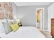 Serene bedroom with ensuite bathroom access and wood wall art at 1695 Sugarbelle Cir, Mascotte, FL 34753