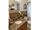 Updated bathroom with granite vanity and tile flooring at 306 Medina Ct, Kissimmee, FL 34758