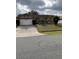 Two-car garage and a neatly landscaped front yard at 306 Medina Ct, Kissimmee, FL 34758