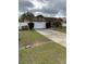 Single-story house with a two-car garage and a well-maintained lawn at 306 Medina Ct, Kissimmee, FL 34758