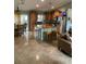 Spacious kitchen with an island, wood cabinets, and tile flooring at 306 Medina Ct, Kissimmee, FL 34758