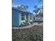 Side view of teal house with a walkway and landscaping at 3407 Avenue J Nw, Winter Haven, FL 33881