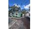 Another view of the teal house with a shed and a fenced yard at 3407 Avenue J Nw, Winter Haven, FL 33881