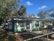 Quaint teal house with a small front yard and fenced area at 3407 Avenue J Nw, Winter Haven, FL 33881