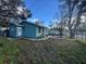 View of teal house from the side yard, showing a spacious area at 3407 Avenue J Nw, Winter Haven, FL 33881