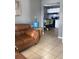Living room with leather couch and view of kitchen at 3407 Avenue J Nw, Winter Haven, FL 33881