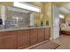 Double vanity bathroom with granite countertop and view to bedroom at 5043 Vantage Ct, St Cloud, FL 34772
