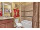 Bathroom with tub, toilet, and granite countertop at 5043 Vantage Ct, St Cloud, FL 34772