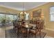 Bright dining room with a formal table setting and access to outdoor patio at 5043 Vantage Ct, St Cloud, FL 34772