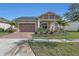 Newly built home with attractive landscaping, a 2 car garage and inviting porch at 5043 Vantage Ct, St Cloud, FL 34772