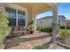 Relaxing front porch with a brick floor, seating area, and potted plants at 5043 Vantage Ct, St Cloud, FL 34772
