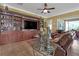 Gathering room featuring a built-in entertainment center and leather seating at 5043 Vantage Ct, St Cloud, FL 34772