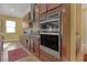 Double oven and gas cooktop in modern kitchen at 5043 Vantage Ct, St Cloud, FL 34772