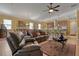 Open living area with leather sofas, adjacent to kitchen and dining areas at 5043 Vantage Ct, St Cloud, FL 34772