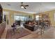 Spacious living room featuring leather furniture and a large glass sliding door leading to the outdoors at 5043 Vantage Ct, St Cloud, FL 34772