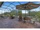 Relaxing screened lanai with patio furniture and lush landscaping at 5043 Vantage Ct, St Cloud, FL 34772