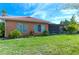 House exterior and backyard with lush lawn and screened patio at 521 Milano Rd, Kissimmee, FL 34759