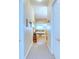 Clean hallway with carpet flooring and access to bathroom at 521 Milano Rd, Kissimmee, FL 34759