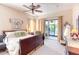 Spacious main bedroom with a king-size bed and private access to the patio at 521 Milano Rd, Kissimmee, FL 34759