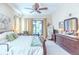 Main bedroom with king bed, dresser, and patio access at 521 Milano Rd, Kissimmee, FL 34759