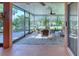 Relaxing screened porch with paver patio, wicker furniture, and lake view at 521 Milano Rd, Kissimmee, FL 34759