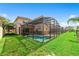This home boasts a private backyard pool and lush landscaping at 8958 Sugar Palm Rd, Kissimmee, FL 34747