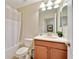 Bathroom with tub, shower and wood vanity at 8958 Sugar Palm Rd, Kissimmee, FL 34747