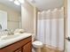 Simple bathroom with shower, toilet and wood vanity at 8958 Sugar Palm Rd, Kissimmee, FL 34747