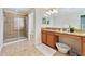 Elegant bathroom with granite double vanity and large shower at 8958 Sugar Palm Rd, Kissimmee, FL 34747