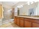 Primary bathroom with double sinks, granite countertop and shower at 8958 Sugar Palm Rd, Kissimmee, FL 34747