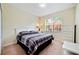 Spacious bedroom with a white dresser and a plaid comforter at 8958 Sugar Palm Rd, Kissimmee, FL 34747