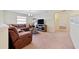 Cozy bonus room features a sectional sofa and flat-screen TV at 8958 Sugar Palm Rd, Kissimmee, FL 34747