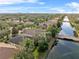 Wide aerial view of a community with houses and waterways at 12021 Jewel Fish Ln, Orlando, FL 32827