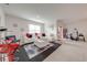 Spacious living room with white sectional sofa, red accents, and large windows at 1242 Iguana Loop, Davenport, FL 33897