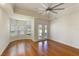 Hardwood floor bedroom with large window and ceiling fan at 1280 Osprey Landing Dr, Lakeland, FL 33813