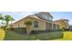 Side view of the house highlighting the screened patio and landscaping at 1280 Osprey Landing Dr, Lakeland, FL 33813