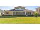 House back elevation showcasing a screened patio and spacious backyard at 1280 Osprey Landing Dr, Lakeland, FL 33813