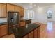 Island kitchen with stainless steel appliances and granite countertops at 1280 Osprey Landing Dr, Lakeland, FL 33813
