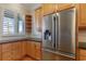 Modern kitchen with stainless steel refrigerator and wood cabinets at 1280 Osprey Landing Dr, Lakeland, FL 33813