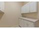 Laundry room with white cabinets and a built in sink at 1280 Osprey Landing Dr, Lakeland, FL 33813