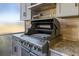 Stainless steel grill with open lid, showcasing its interior at 1280 Osprey Landing Dr, Lakeland, FL 33813