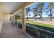 Spacious screened porch overlooking a lush golf course and lake at 1280 Osprey Landing Dr, Lakeland, FL 33813