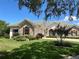 Luxury home with stone accents and lush landscaping at 1501 Sunset Pointe Pl, Kissimmee, FL 34744