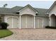 Three-car garage with paver driveway at 1501 Sunset Pointe Pl, Kissimmee, FL 34744