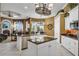 Open kitchen with large island, granite counters, and stainless steel appliances at 1501 Sunset Pointe Pl, Kissimmee, FL 34744